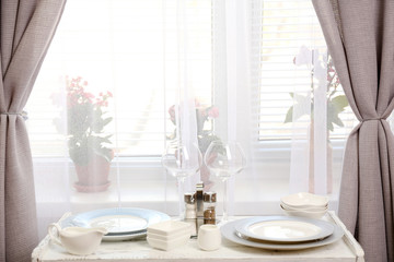 Different tableware on shelf in the interior