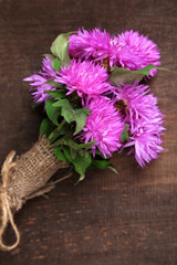 Cornflowers on wooden background