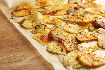 Homemade potato chips on wooden table