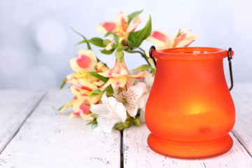 Bright icon-lamp with flowers on table on bright background