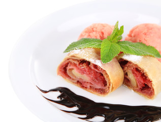 Tasty homemade strudel with ice-cream, chocolate sauce and mint