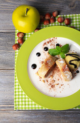 Tasty homemade apple strudel with nuts, mint leaves and