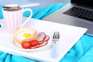 Composition with laptop and tasty breakfast