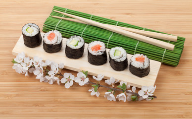 Sushi maki set with fresh sakura branch
