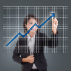 Closeup of young Asian business woman drawing graph