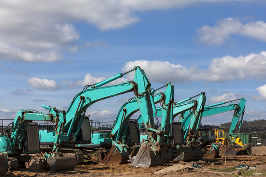 Green earthmoving machines ready for action on housing project