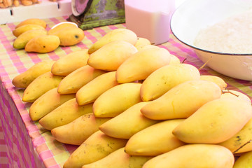 Ripe yellow mangoes in the market