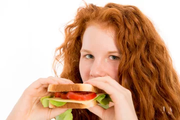 Deurstickers red haired girl eating sandwich © Firma V