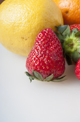 Fresh strawberry and orange close up