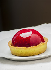Strawberry tart on white background close up