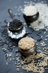 Raw rice kernels of different types, vertical shot