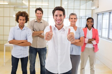 Workers giving thumbs up to camera