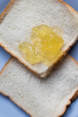 Slice of white toast topped with vibrant orange .