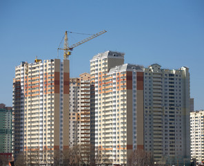 Fototapeta na wymiar New building construction over blue clear cloudless sky