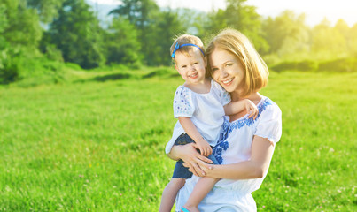 happy family on nature mother and baby daughter