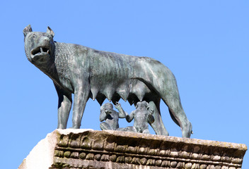she-wolf nursing twins while founders of Rome with blue sky back