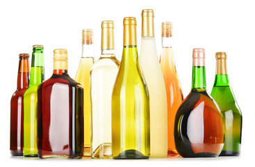 Bottles of assorted alcoholic beverages isolated on white