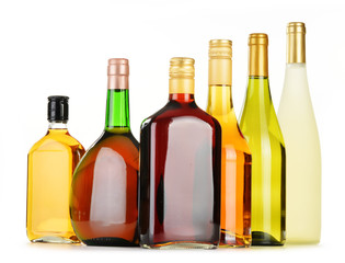 Bottles of assorted alcoholic beverages isolated on white