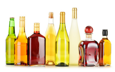 Bottles of assorted alcoholic beverages isolated on white