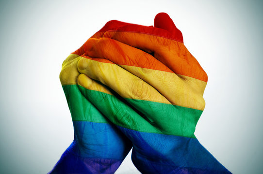 man hands patterned as the rainbow flag