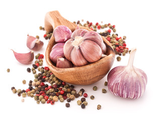 Garlic cloves in wooden bowl isolated on white background