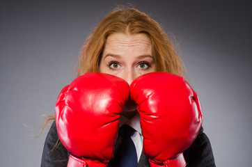 Woman boxer in dark room