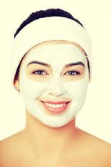 Beautiful woman with clay facial mask