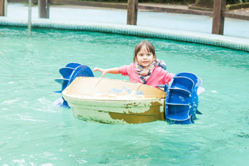 Young girl in a pedal boat