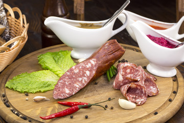 sausages on a wooden plate with vegetables in a restaurant