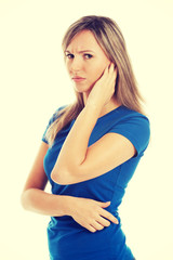 Fototapeta premium Young casual woman touching her ear.