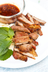 Grilled beef steak with spicy sauce.
