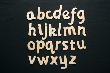 Wooden letters of the alphabet on a blackboard