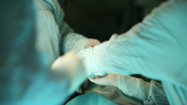 Surgeon Wearing Gloves At The Operation Room