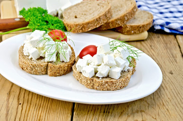 Bread with cheese and tomatoes in white plate