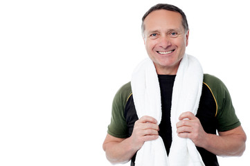 Fitness trainer with towel around his neck