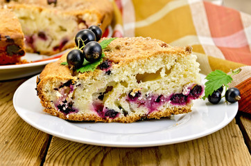 Pie with black currant on board with napkin