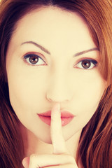 Naklejka premium Woman with finger on her lips.
