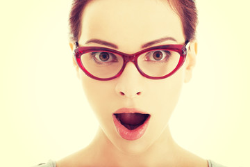 Young surprised woman in eyeglasses.