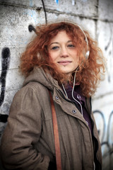 Fototapeta premium Beautiful young girl listening to music