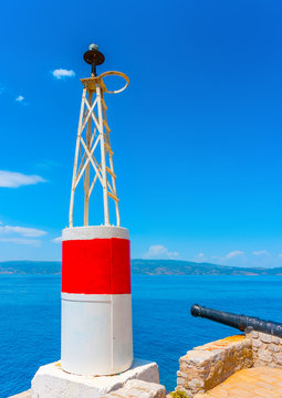 The red port light of the main harbor of Hydra island in Greece
