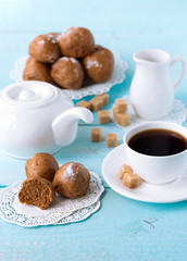 brown buns on blue wooden table with coffee cup