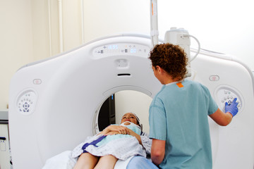 Technician performing CAT scan of patient