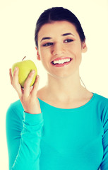 Young casual woman holding an apple.