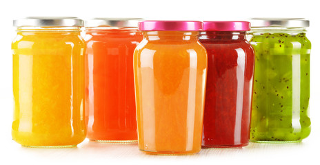 Jars of fruity jams isolated on white background