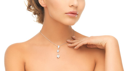 woman wearing shiny diamond pendant