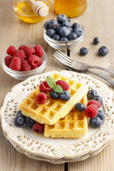 Waffles with syrup, raspberries and blueberries