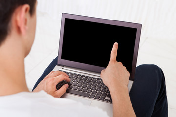 Man Using Laptop At Home