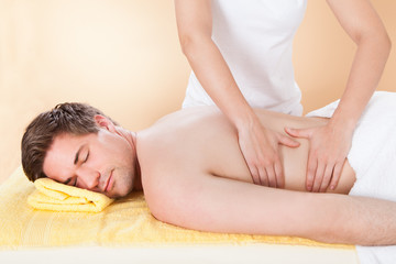 Obraz na płótnie Canvas Man Receiving Back Massaging In Spa