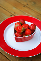 Fresh strawberries on wooden background.