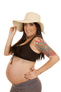 pregnant woman tattoos bikini top hat look smile
